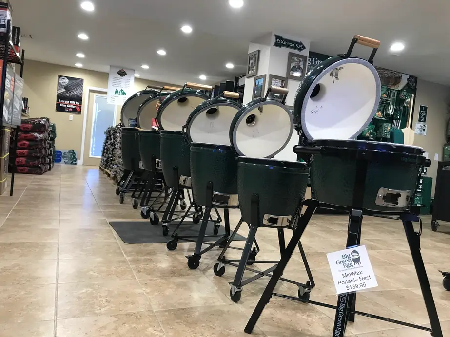 A row of open Big Green Egg ceramic cookers on the Mannix showroom floor